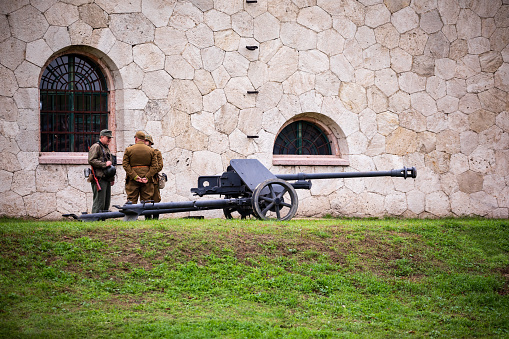 Komarom Hungary fort of Monostor Oct. 2, 22: Reenactors with a German field gun at World War II when the German Wehrmacht, SS Soldiers Fighting with invading Soviet red army forces. Free public event.