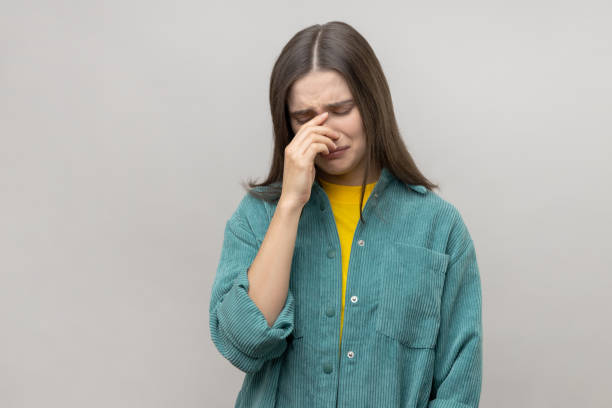 istock Woman holding her head down, touching face and crying with dramatic grimace, feeling sorrow regret. 1631878090
