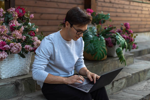 istock A student is working at a laptop in the park. 1631878638