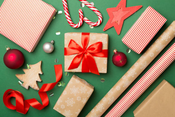 istock Gift boxes, paper's rools and decorations on color background, top view 1631880294