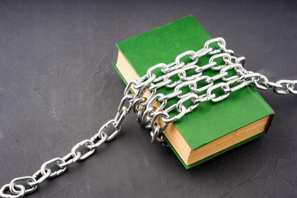 istock a large green book chained on a gray background 1631887454