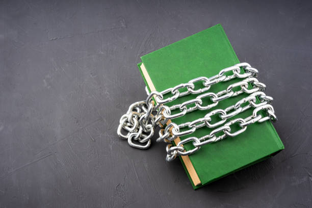 istock a green book without an inscription on the cover is compressed by a chain, prohibited reading literature 1631887456
