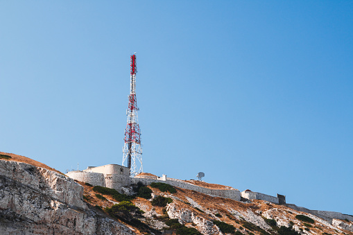 Fort of Pomegues and communication antenna on top of the hill in Frioul calanques. Taken in Marseille city, on the Mediterranean coast of Provence, in the department of Bouches-du-Rhone, in Provence-Alpes-Cote d'Azur region in France, Europe in a summer sunny day.
