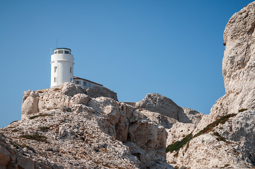 Frioul island with its calanques, creeks and beautiful lighthouse. Taken in Marseille city, on the Mediterranean coast of Provence, in the department of Bouches-du-Rhone, in Provence-Alpes-Cote d'Azur region in France, Europe in a summer sunny day.