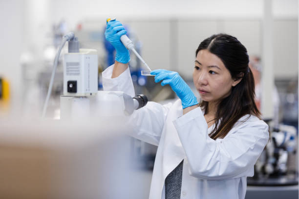 Female doctoral student conducts experiments in college lab stock photo