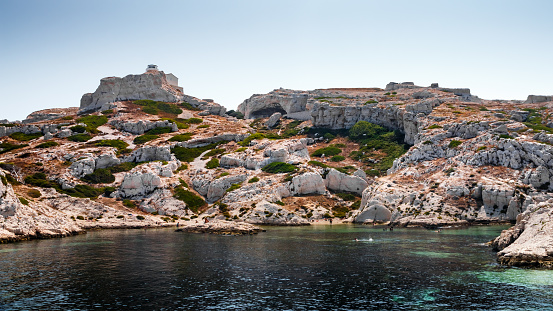 Frioul island with its calanques, creeks and beautiful lighthouse. Taken in Marseille city, on the Mediterranean coast of Provence, in the department of Bouches-du-Rhone, in Provence-Alpes-Cote d'Azur region in France, Europe in a summer sunny day.