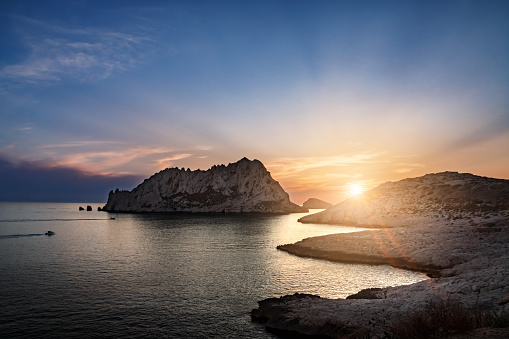 Beautiful bright sunset over the creeks of the Mediterranean Sea, seen from Calanques of Callelongue in Les Goudes town. Taken near Marseille city, on the Mediterranean coast of Provence, in the department of Bouches-du-Rhone, in Provence-Alpes-Cote d'Azur region in France, Europe in a summer.