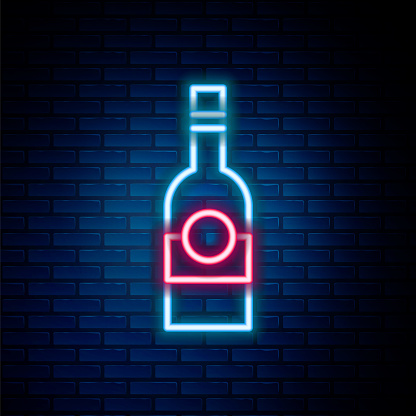 Glowing neon line Glass bottle of vodka icon isolated on brick wall background. Colorful outline concept. Vector.