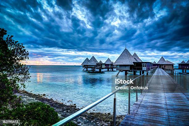 Tropical Paradise Luxury Over Water Resort At Sunset Stock Photo - Download Image Now