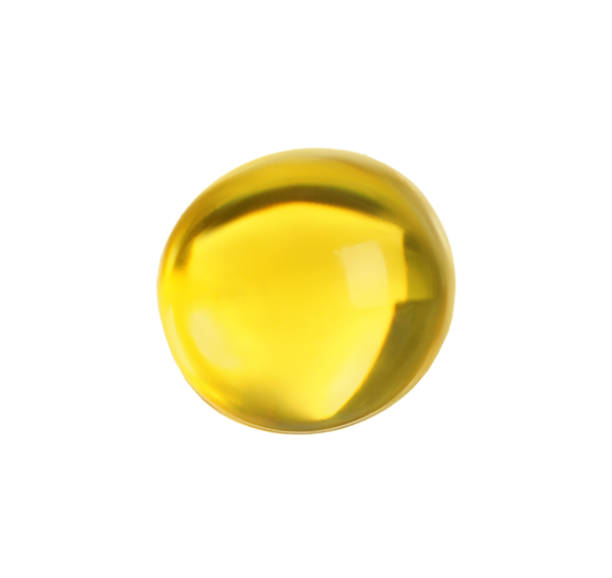 istock One yellow pill isolated on white. Medicinal treatment 1631956874