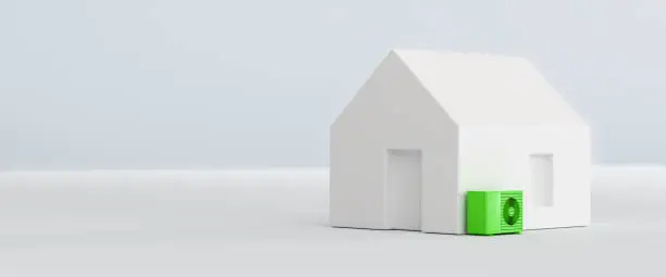 Model home with a green heatpump. Concept for sustainable heating with electric heatpumps.