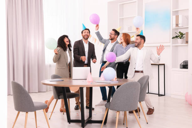 istock Coworkers having fun during office party indoors 1631968668