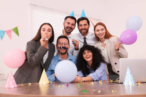 istock Coworkers having fun during office party indoors 1631973180