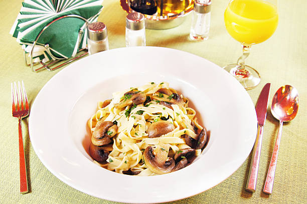 istock Tagliatelle pasta with mushrooms on a laid table 163198097