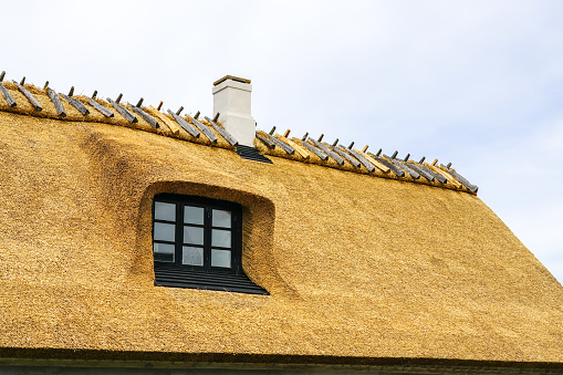New thatch roof over house with dormer window in Denmark, Europe, thatched roof, white chimney