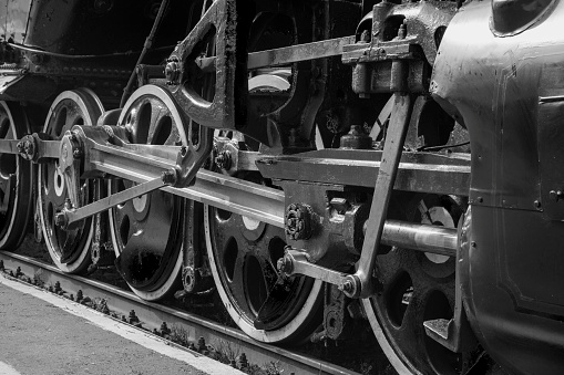 An old steam locomotive of the early 20th century on the railway track.