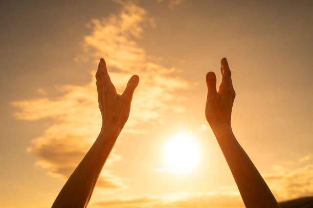 istock Worshiping hands up to the sky. 1632010959