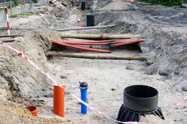 istock Street reconstruction view with deep trench, old and replaced underground pipes, new plastic well 1632012083