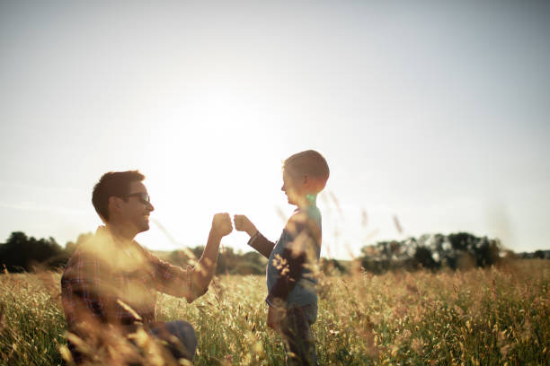 istock Father and son having fun in the meadow. 1632018174