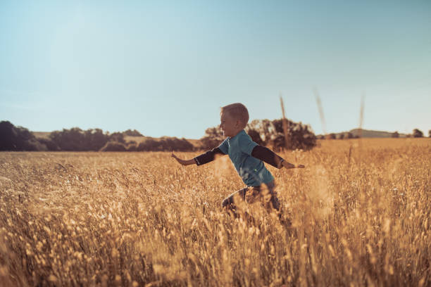 istock Happy boy running in the field. 1632018180