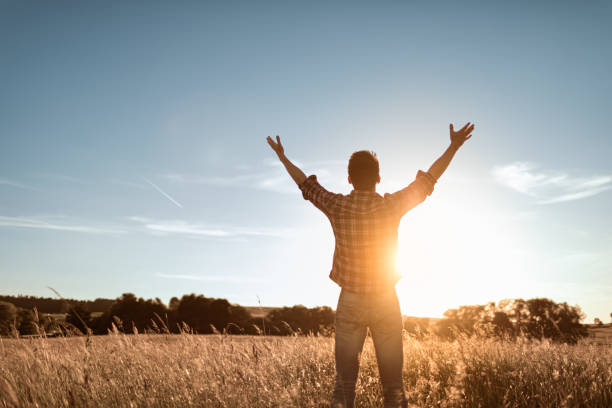 istock Young man feeling grateful, joyful standing outdoors in the sunrise. 1632019254