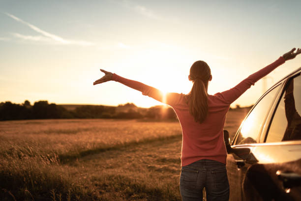 istock Road trip. Woman enjoying beautiful sunset. 1632019783