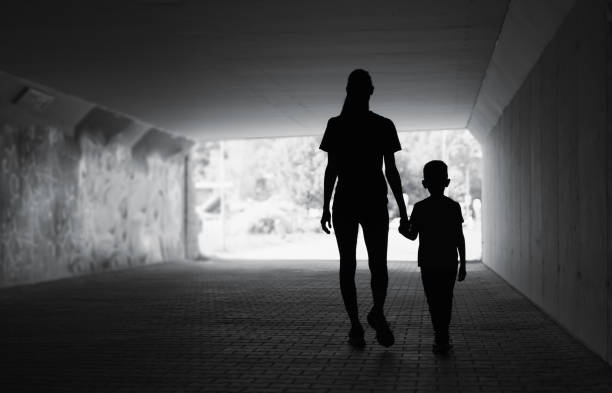istock Mother and son walking in the city. 1632019788