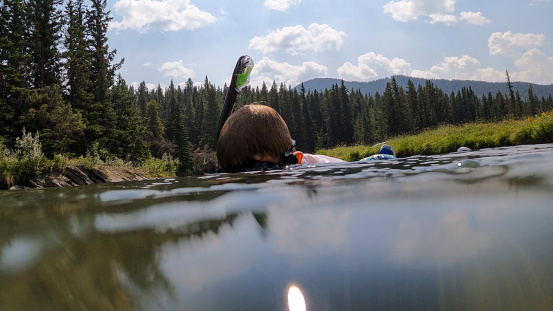 He explores a river with his snorkelling gear in Crowsnest Pass