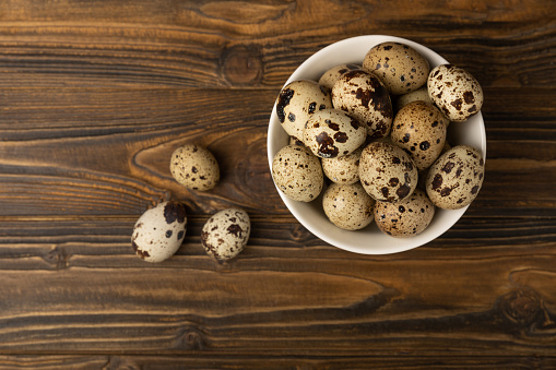 Quail eggs on a  texture background.Organic food. Place for text. Fresh quail eggs.