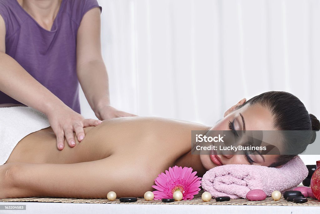 massage Woman receiving massage on back in spa center Adult Stock Photo