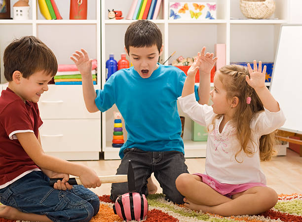 istock Children playing with a piggybank 163204619