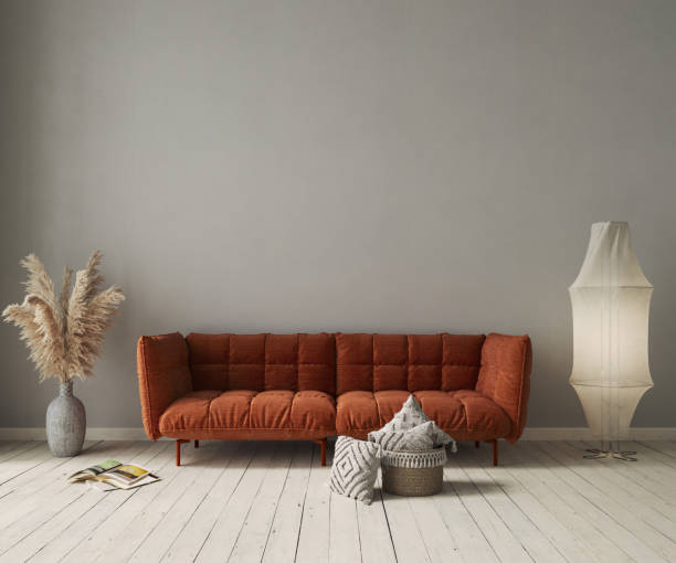 istock Living room interior with orange sofa on gray concrete wall background. Interior mockup, 3d render 1632050878