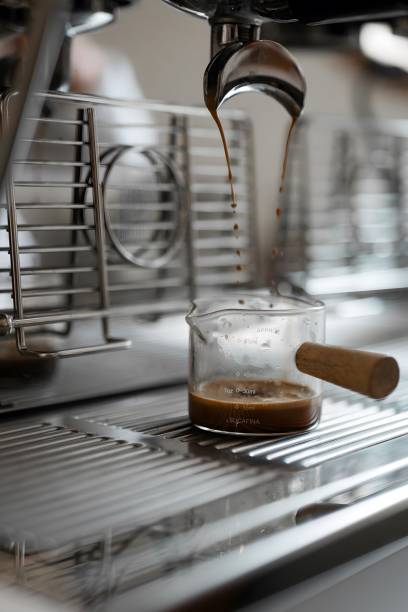 istock espresso pouring from professional coffee brewing coffee machine , close up 3 1632064455