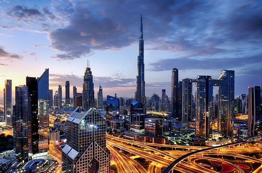 Dubai modern skyline  architecture by night with illuminated skyscrapers, United Arab Emirates