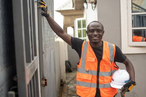 istock a man with hard hats and a construction vest is smiling 1632076932