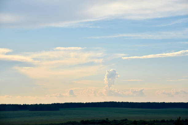 Beautiful thunderstorm landscape in the countryside. Thunderclouds and a horizon with a forest.