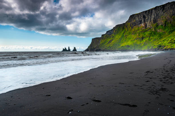 istock The black sand beach in Iceland along with Reynisdrangar 1632093049