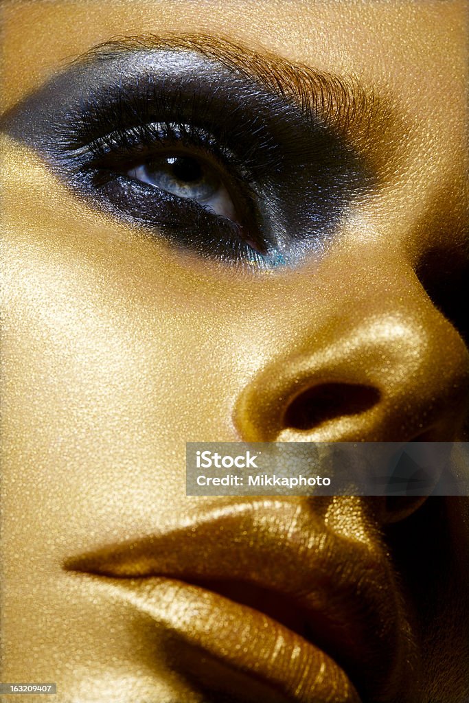 Golden Beauty Beauty portrait, blue eyes, clear skin, professional make-up. studio shot. Gold - Metal Stock Photo