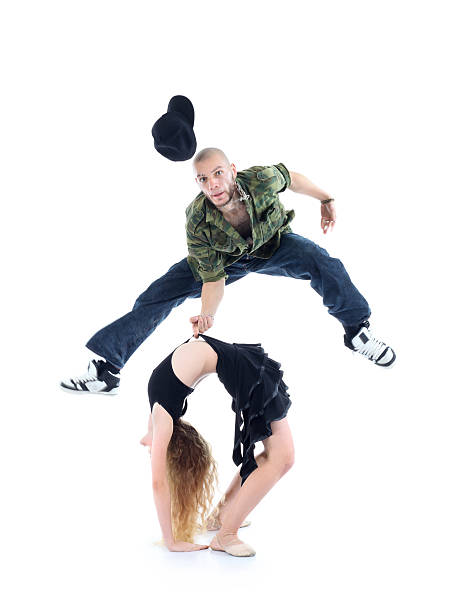 istock Gymnast does bridge and rapper jump above her 163209620