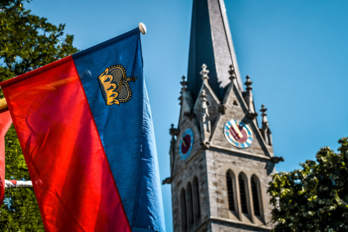 Waving Of A Flag Next To St. Florin Cathedral In Vaduz, Liechtenstein