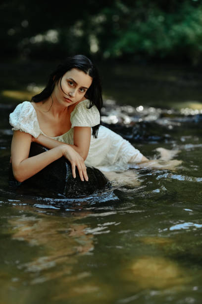 istock Intent Look By Gorgeous Female Relaxing In Cool River Water 1632112928