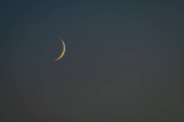istock Moon in middle of summer after color sunset on dark sky 1632116596