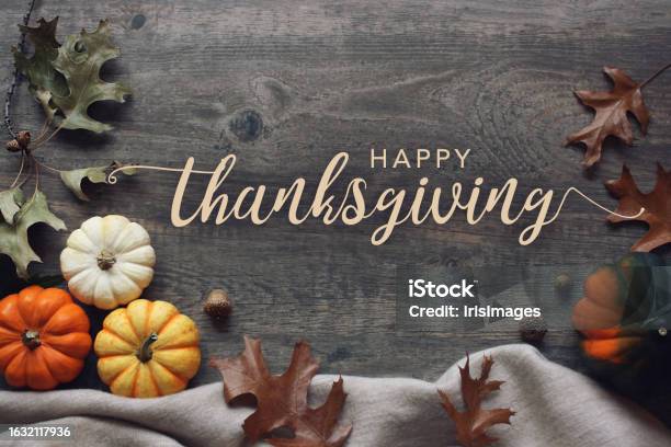 Happy Thanksgiving Day Greeting Card Calligraphy Text With Fall Pumpkins Squash Cozy Warm Blanket And Leaves Over Dark Wood Table Background Stock Photo - Download Image Now