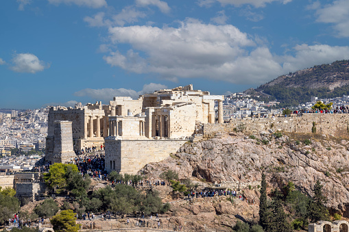 Athens, Greece - October 17, 2022: View of the Acropolis of Athens with Propylaia, monumental ceremonial gateway with Temple of Athena Nike and Pedestal of Agrippa