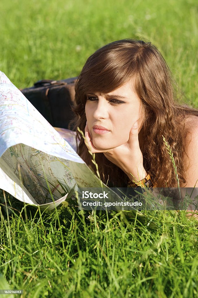 Young woman reading map Adult Stock Photo