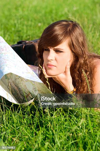 Young Woman Reading Map Stock Photo - Download Image Now - Adult, Analyzing, Beautiful People