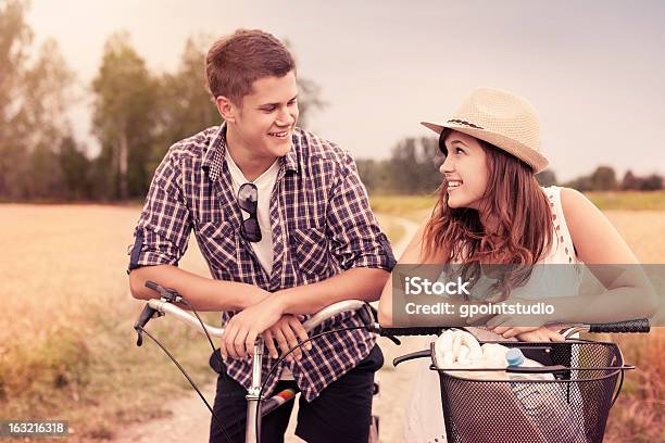 Portrait Of Happy Couple On Bicycles Stock Photo - Download Image Now - 20-29 Years, Adult, Adults Only