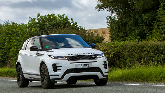 Woburn,Beds.UK - August 19th 2023: 2020 white Range Rover Evoque  car travelling on an English country road.