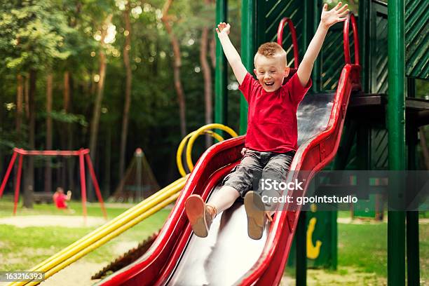 Active Boy Sliding Down Stock Photo - Download Image Now - Child, Slide - Play Equipment, Sliding