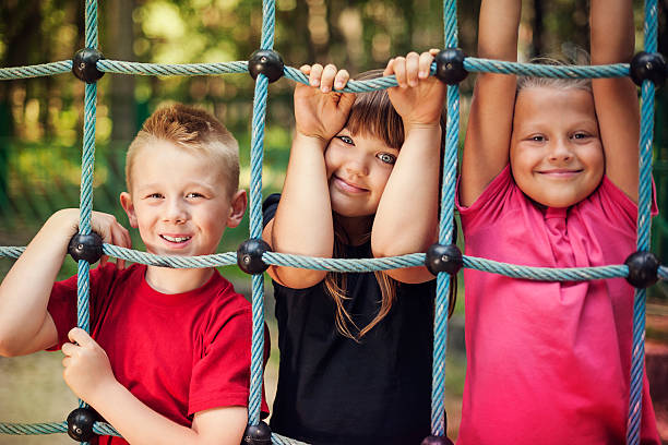 istock Happy children holding a net on playground 163216522